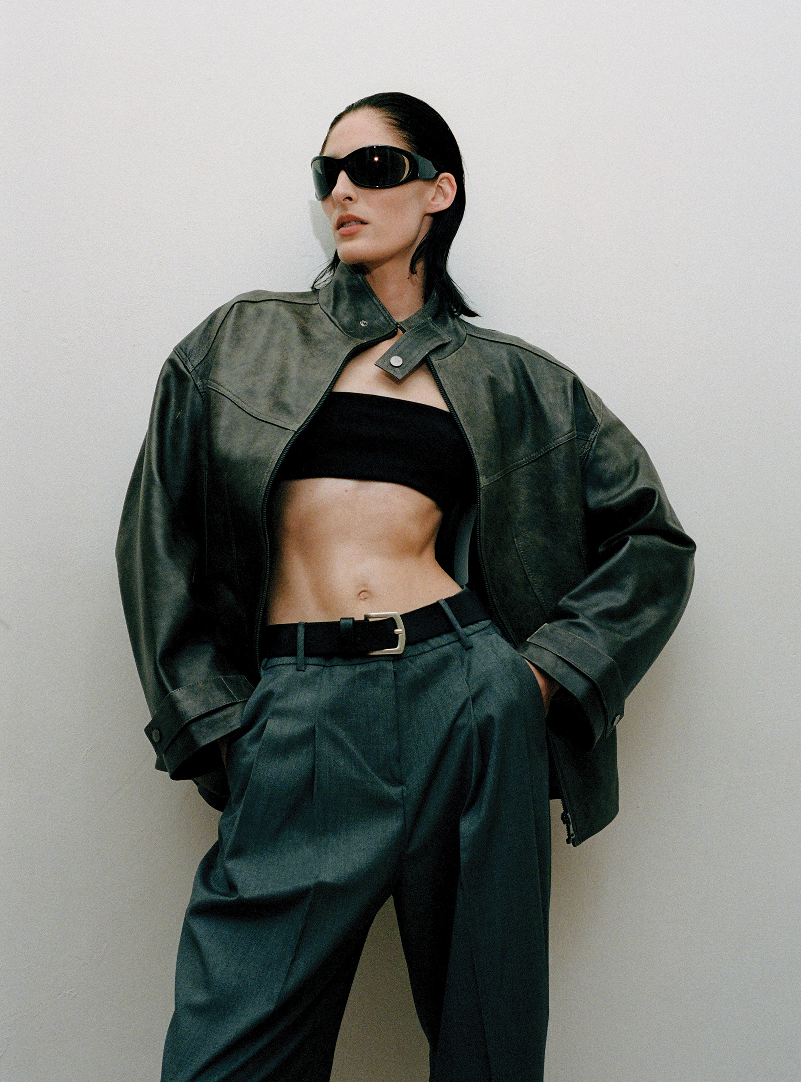 A model standing wearing the Rue Dark Marble leather jacket