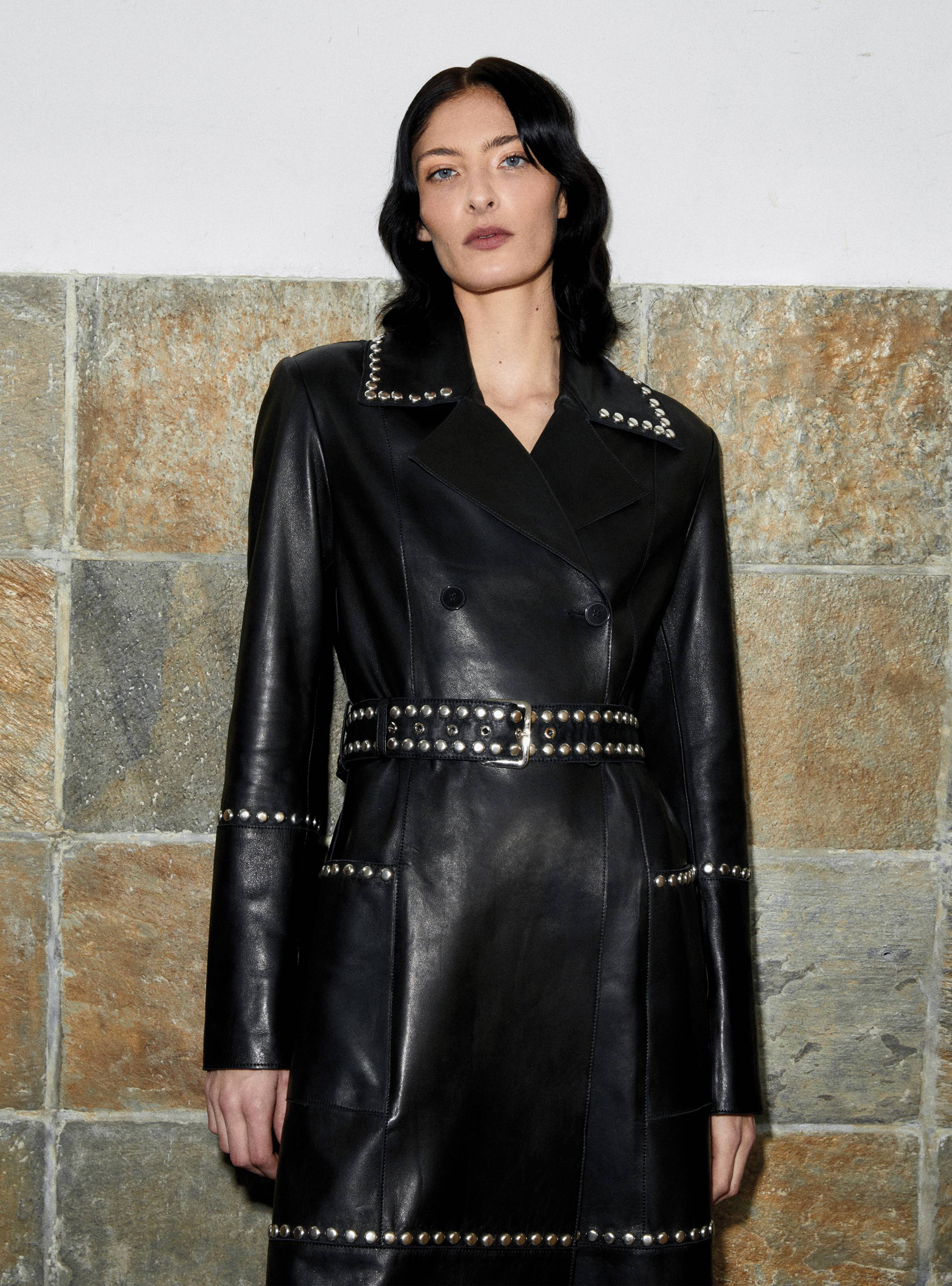 A model looking straight wearing the Icon Black Silver studded leather trench