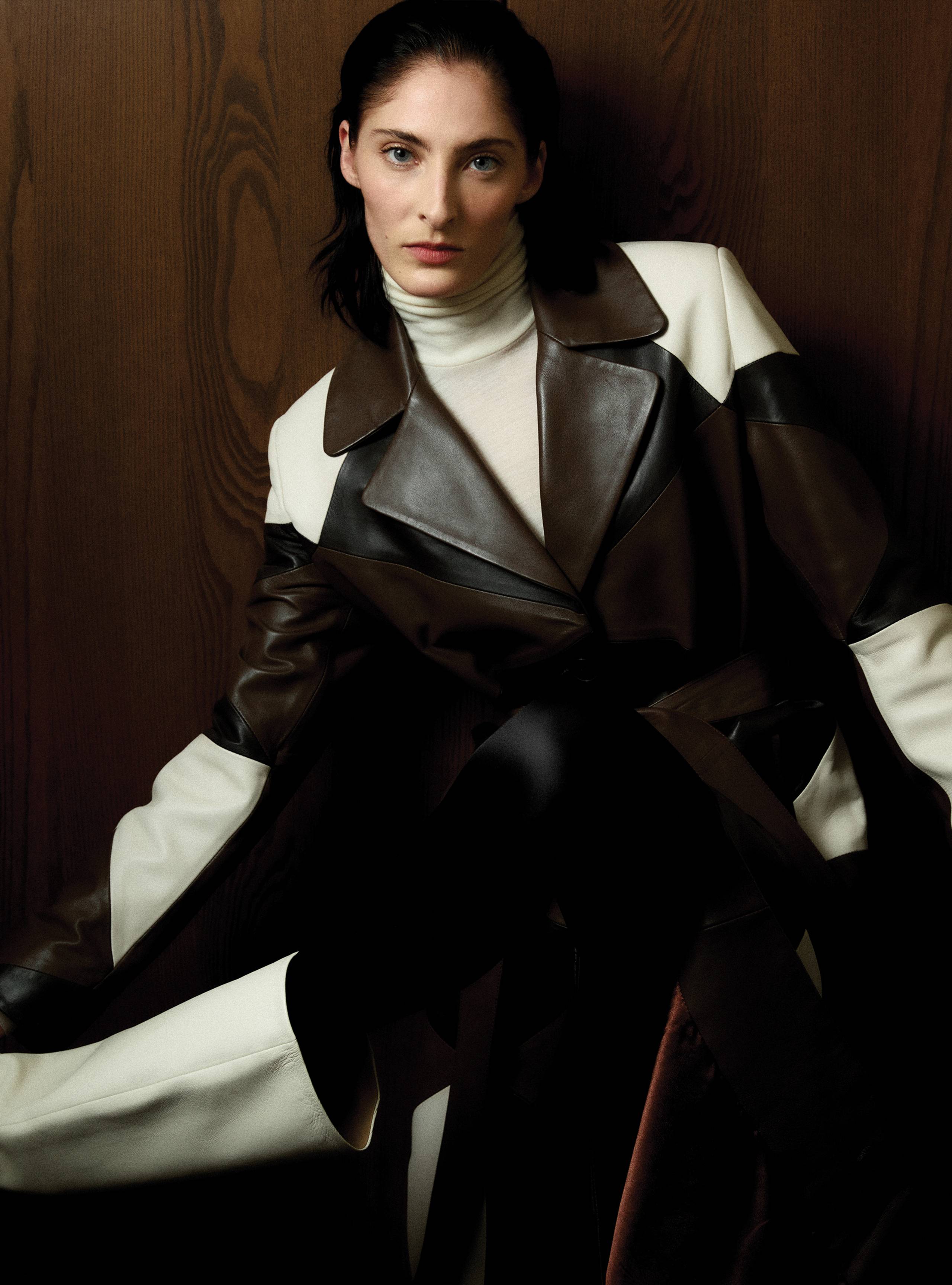 A model sitting wearing the Sonja Cocoa Vanilla Marron coat
