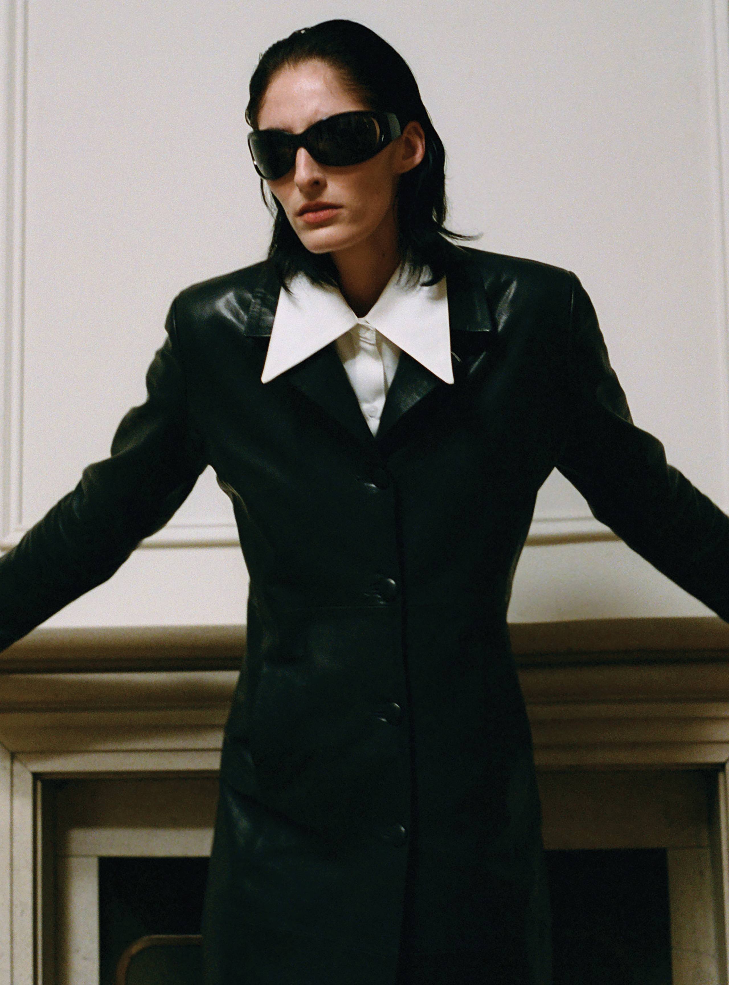 A model wearing the Midnight Black long leather coat