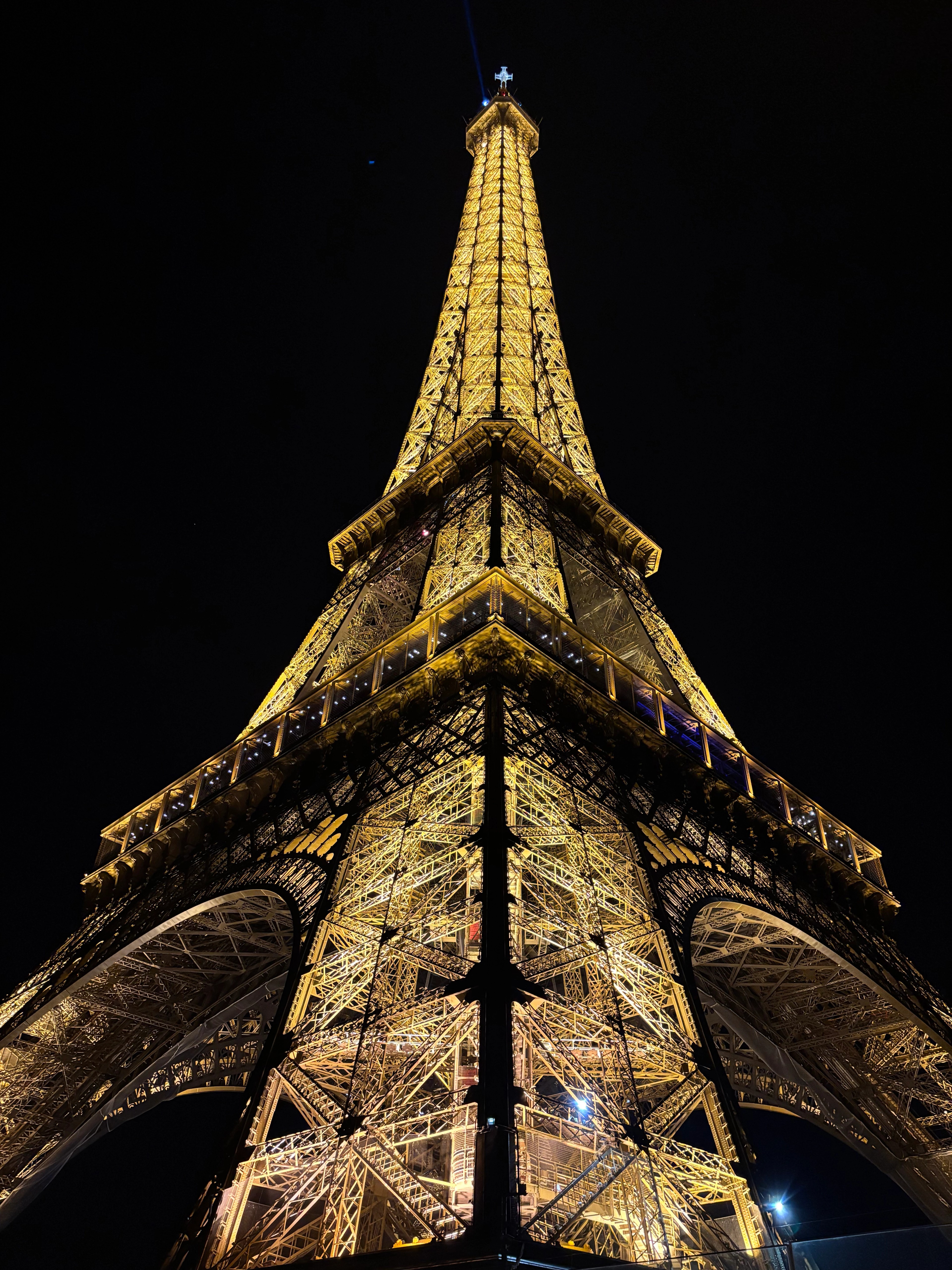 Eiffel tower sparking at night from the ground