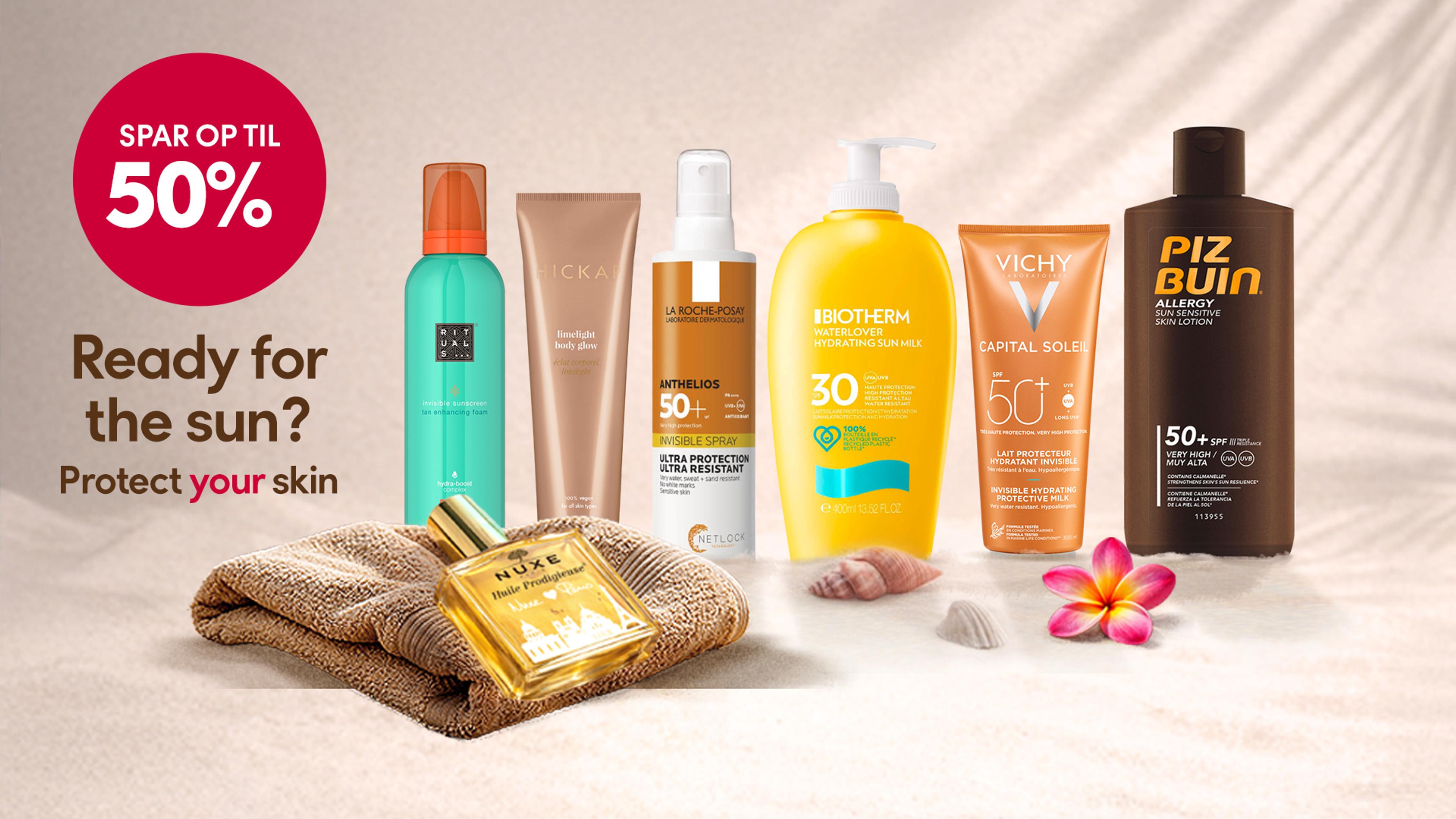 a group of sunscreens sitting on top of each other on a beach .