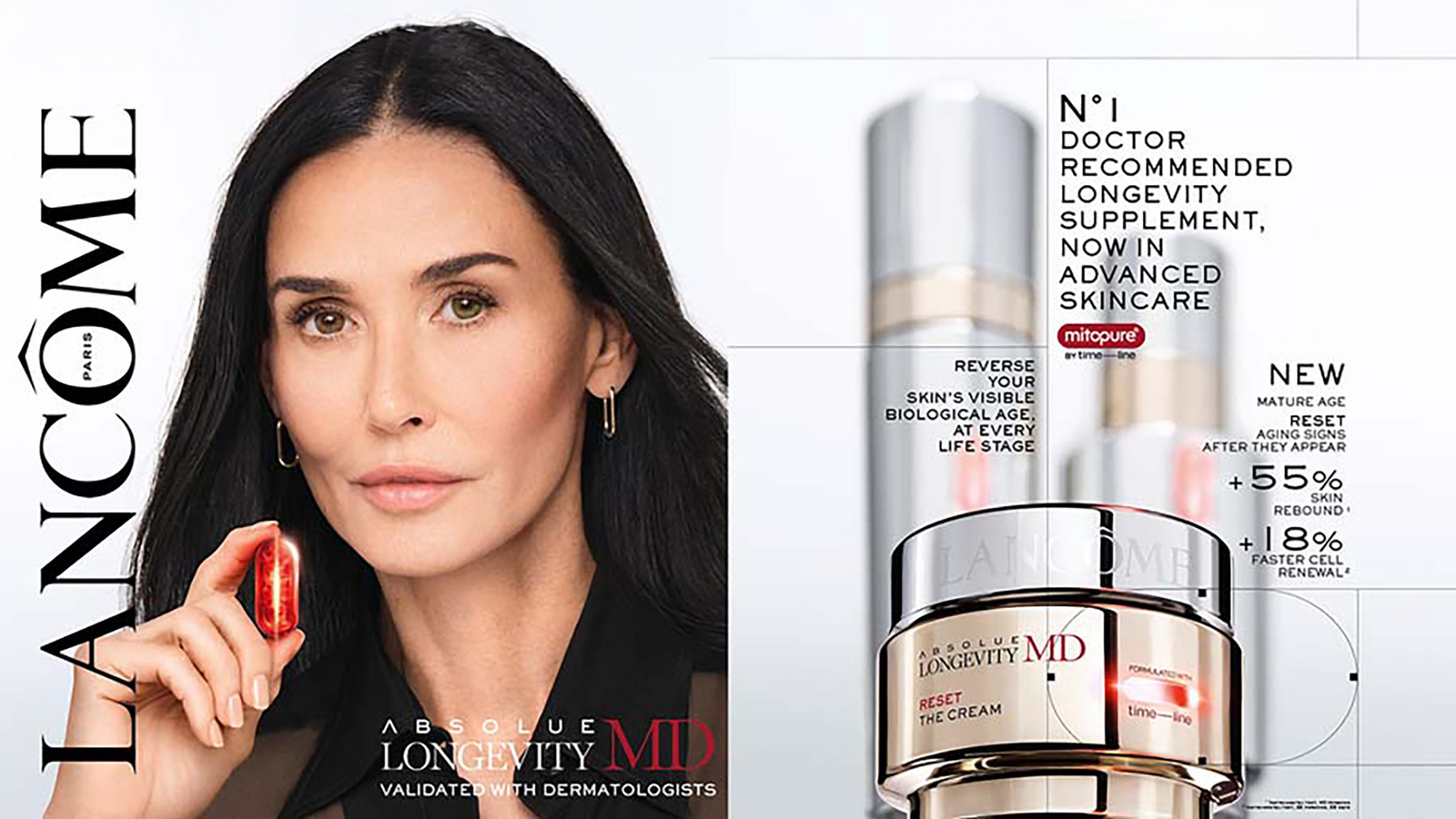 Demi Moore holding a red capsule next to Lancôme Absolue Longevity MD skincare products.