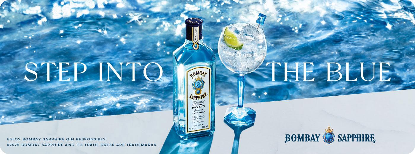 Bombay Sapphire gin bottle and a cocktail glass with lime and ice against a sparkling blue water background, with text "STEP INTO THE BLUE".