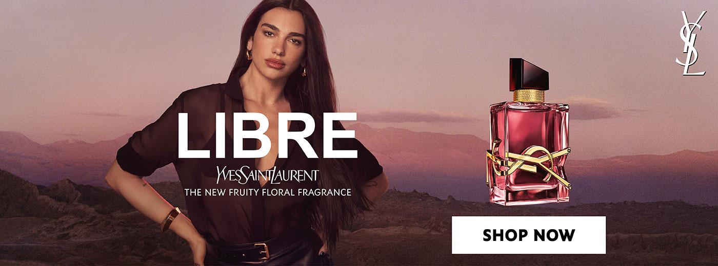 Dua Lipa in a YSL Libre perfume ad, featuring the pink bottle with a gold YSL logo and a 'Shop Now' button.