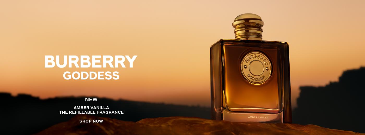 Burberry Goddess Amber Vanilla refillable fragrance bottle against an orange sunset, with promotional text including "SHOP NOW".