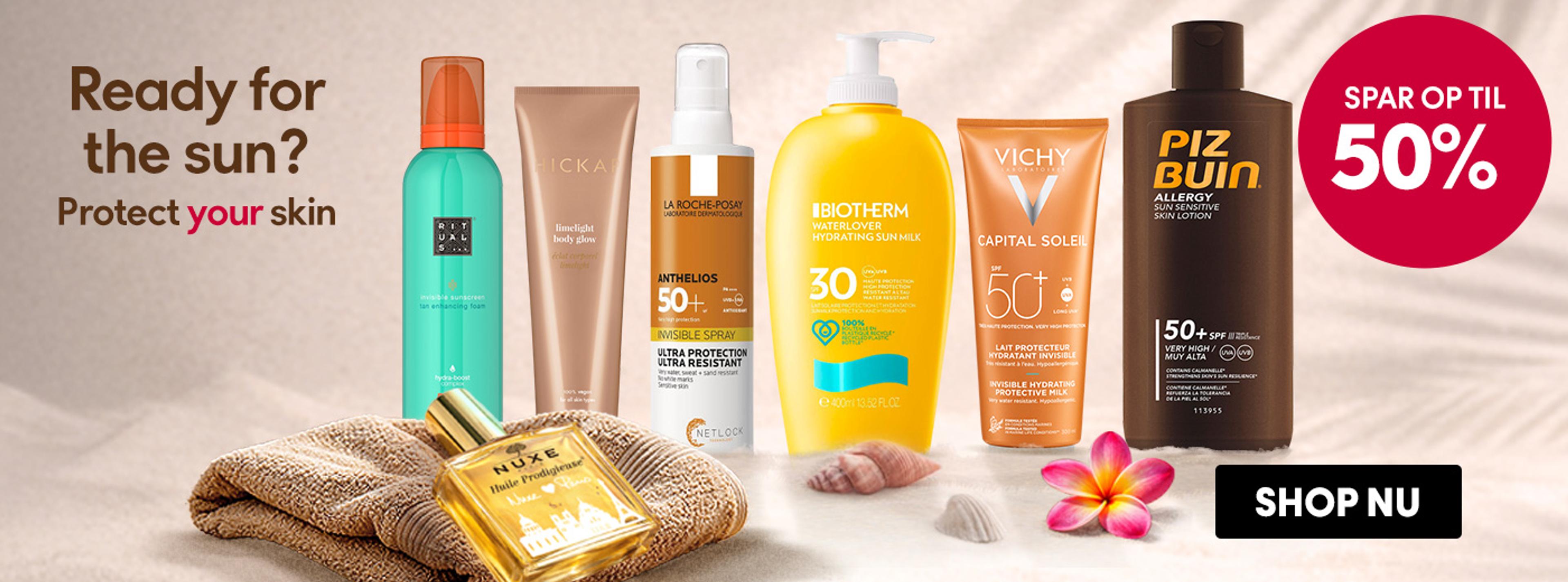 Various sunscreens and skincare products on sand, with text 'Ready for the sun? Protect your skin', 'Save up to 50%', and a 'Shop Now' button.