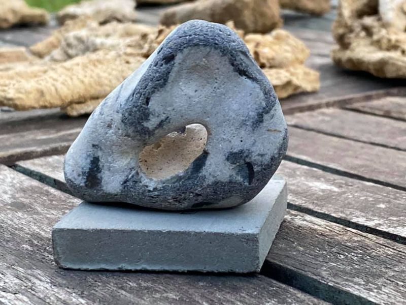 Sculpture of a hagstone on concrete