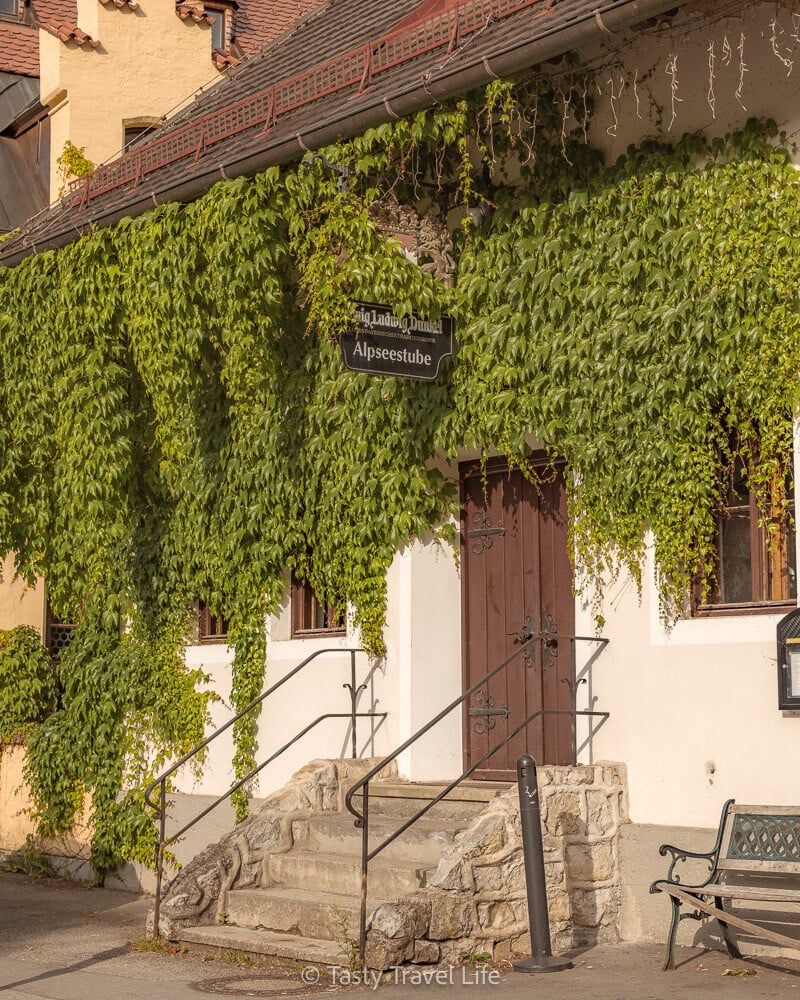 Alpenstube with plants hanging over the entrance 