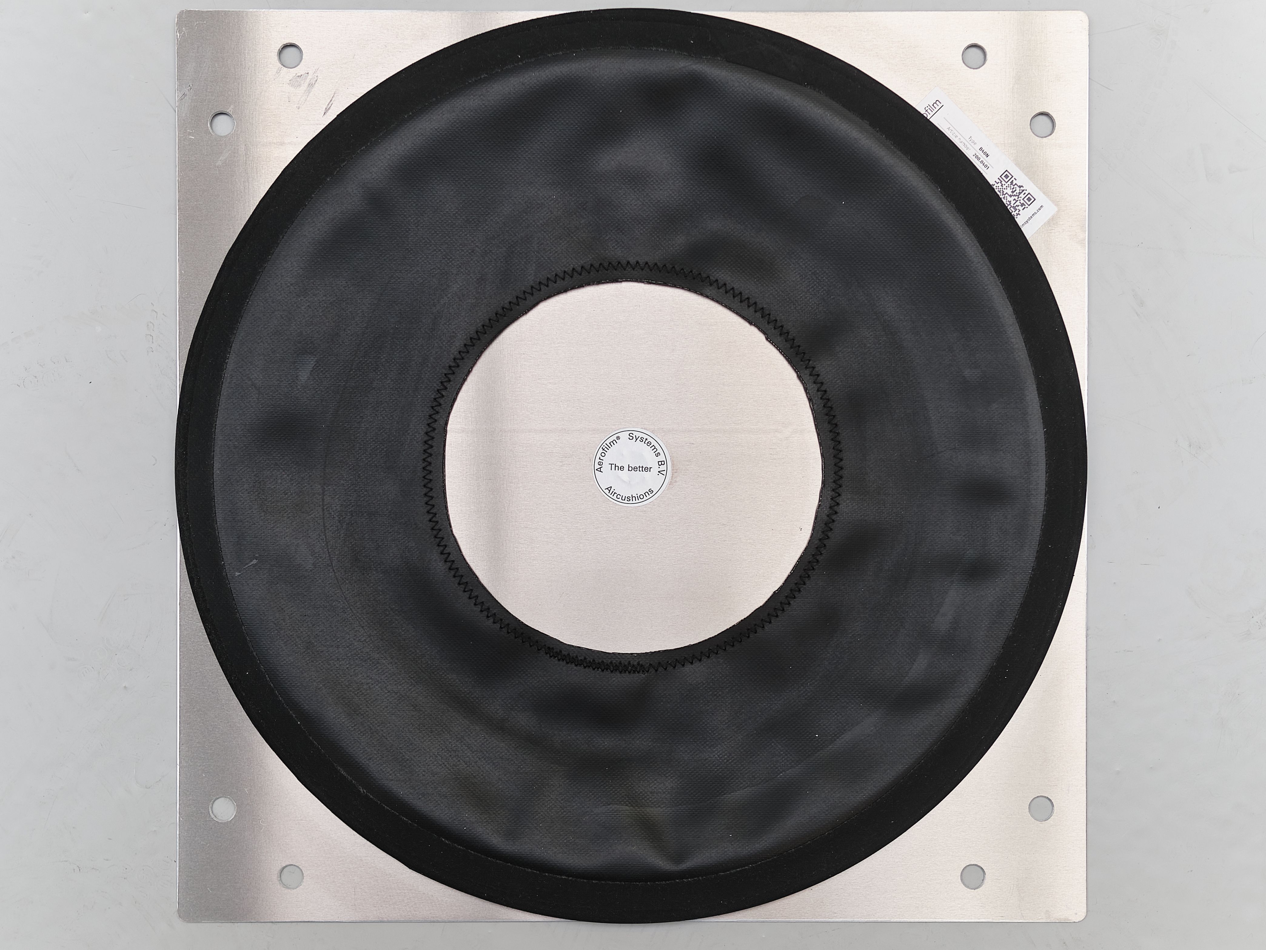 Top view of a neoprene air caster on its support plate