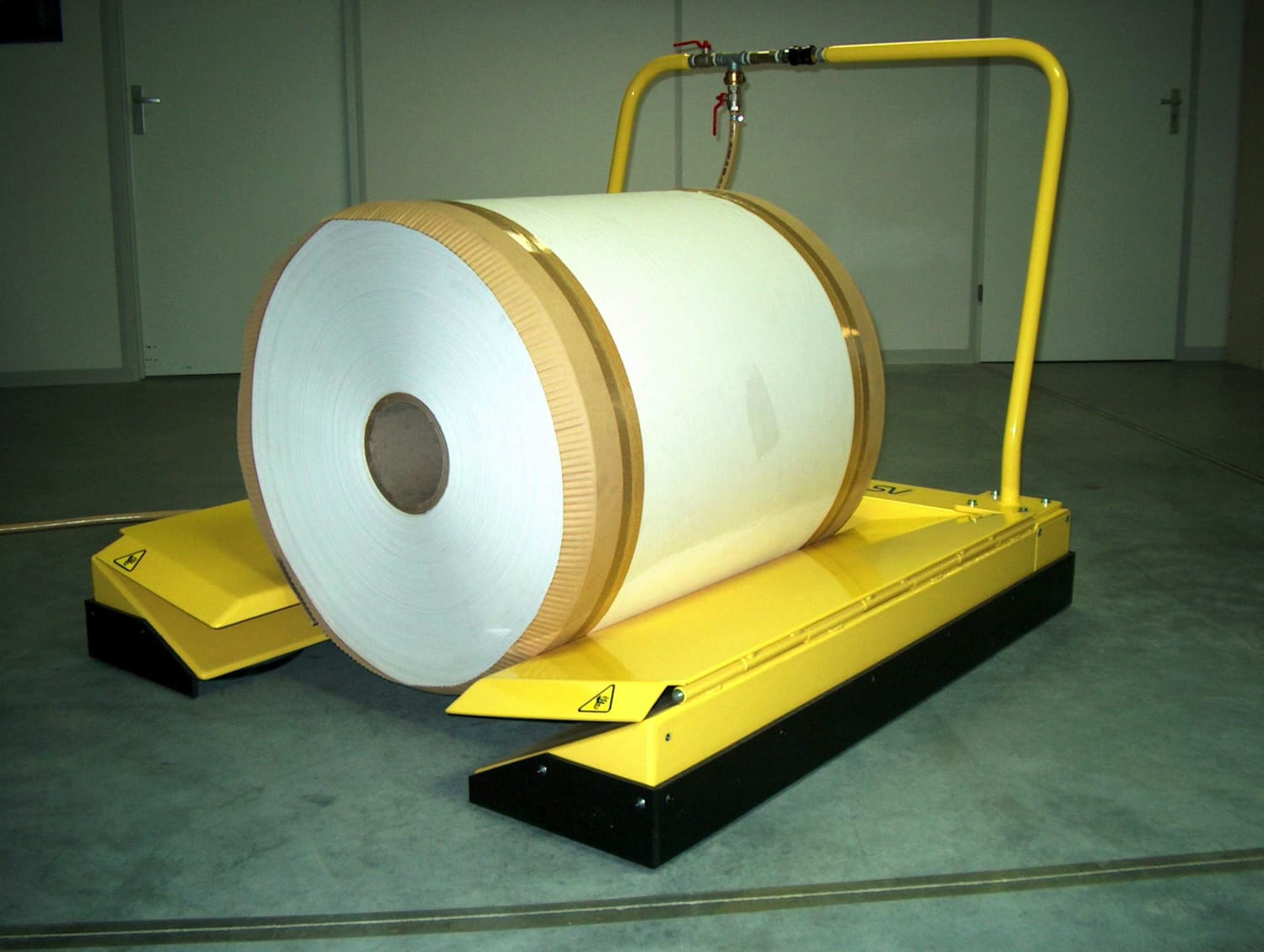 Roll mover carrying a large paper roll