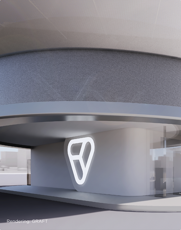 Rundbau mit beleuchtetem Volocopter-Logo an der Fassade