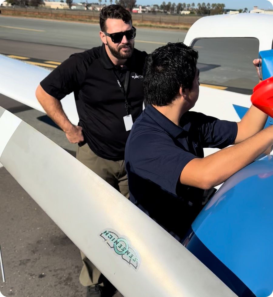 Veteran and Coast instructor preflighting an aircraft on the ramp