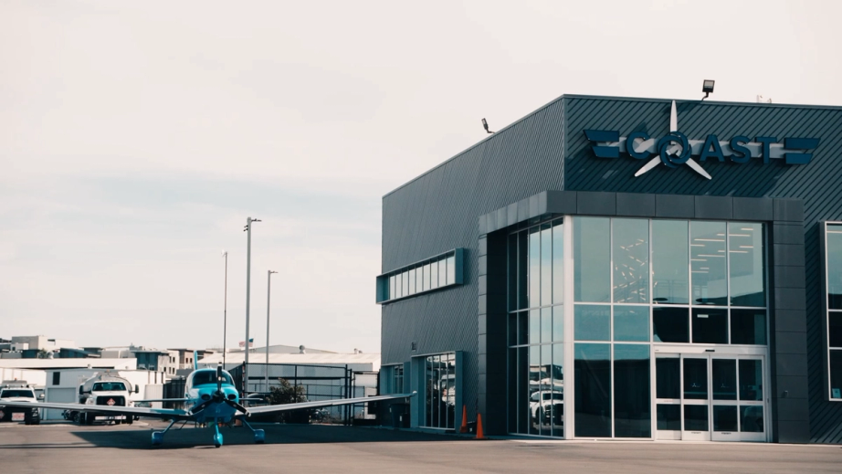 Coast Air Center in San Diego with a Cirrus parked on the ramp out front