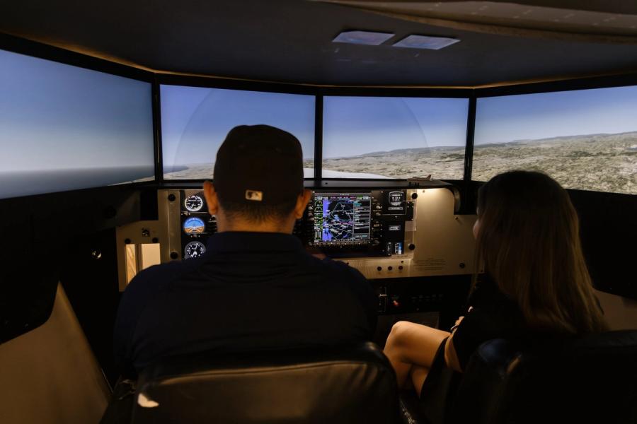 Coast instructor and student side by side in the flight simulator