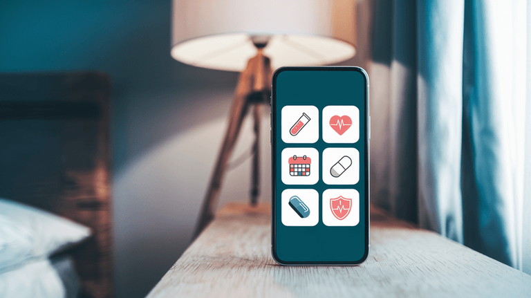 A smartphone sitting on a bedside table displays health-related icons