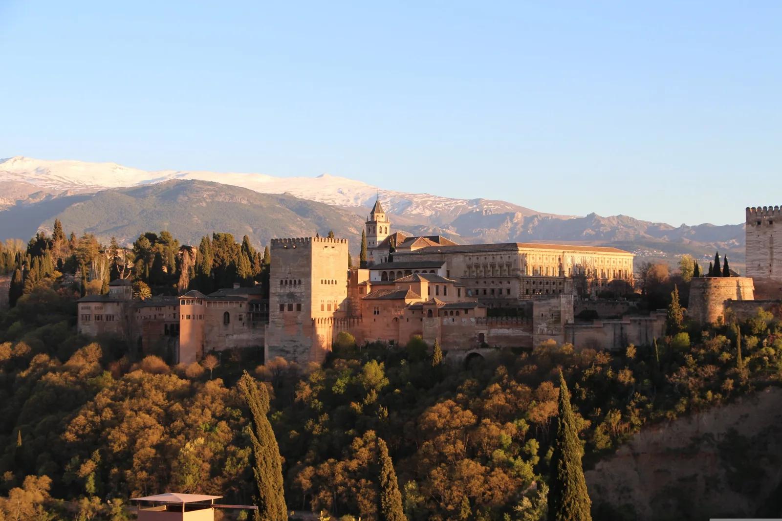 The Alhambra palace in Granada, with the snow-capped Sierra Nevada mountains behind