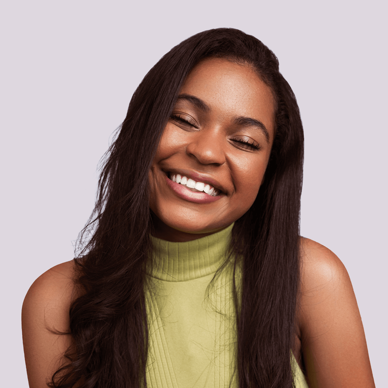 Woman smiling with closed eyes to show off full lashes