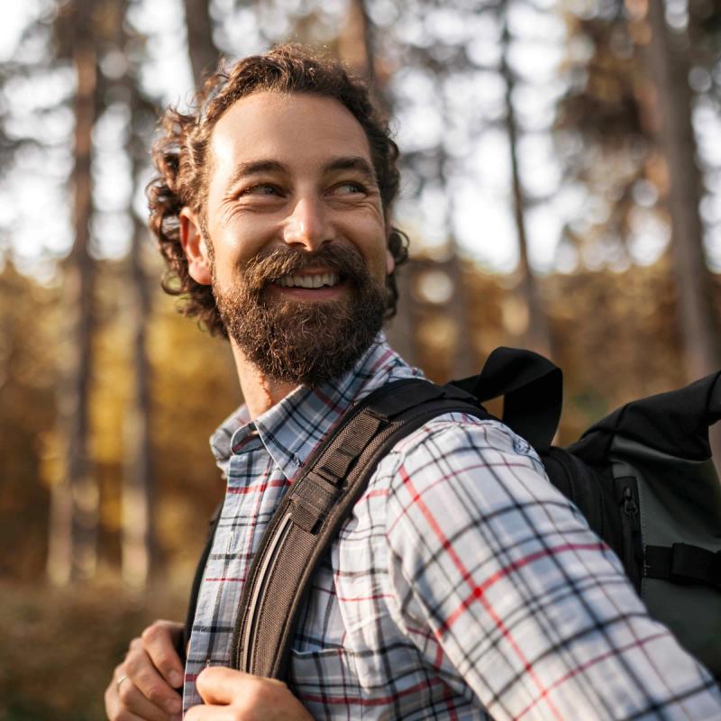 Smiling man hiking outdoors