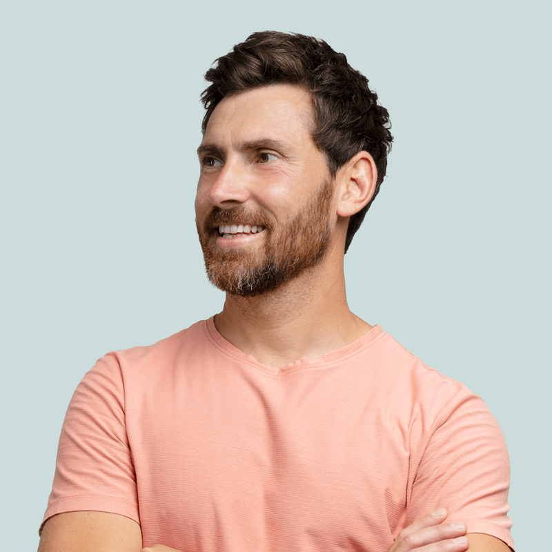 A smiling man looking off to the side