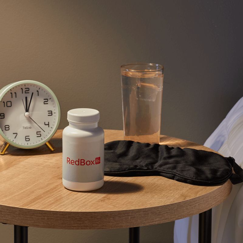 RedBox Rx medication bottle on bedside table