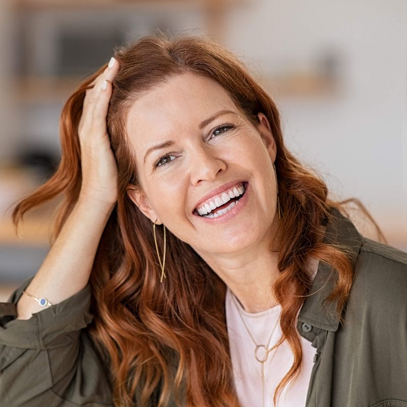 Woman smiling and touching hair