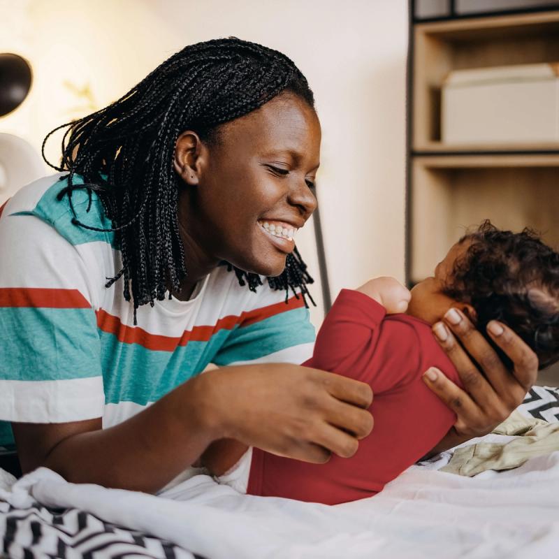 Woman Holding Baby Smiling 