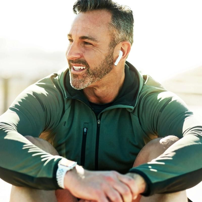 Man Listening to Music Outside With Smile On His Face
