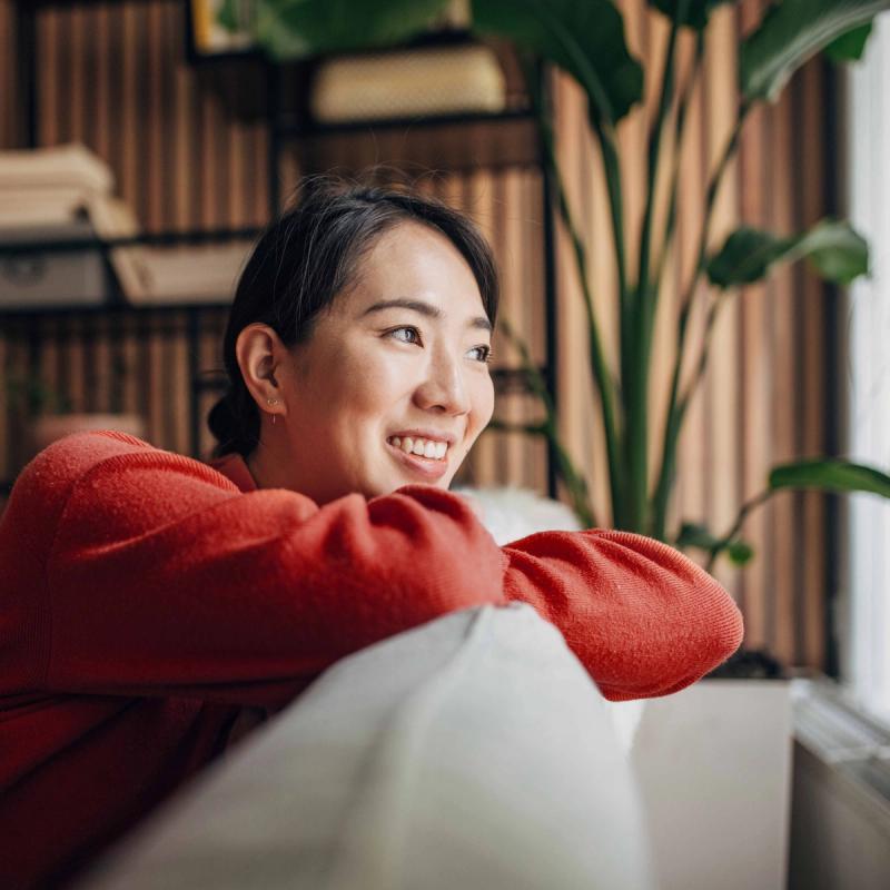 Happy woman smiling and looking out of window