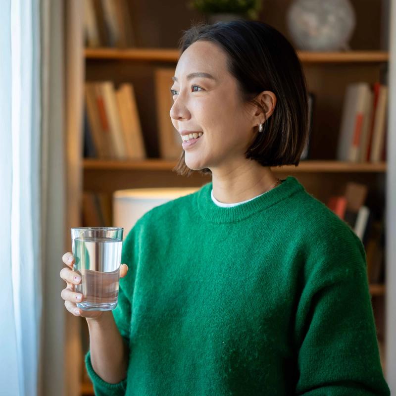 Smiling woman looking out her window