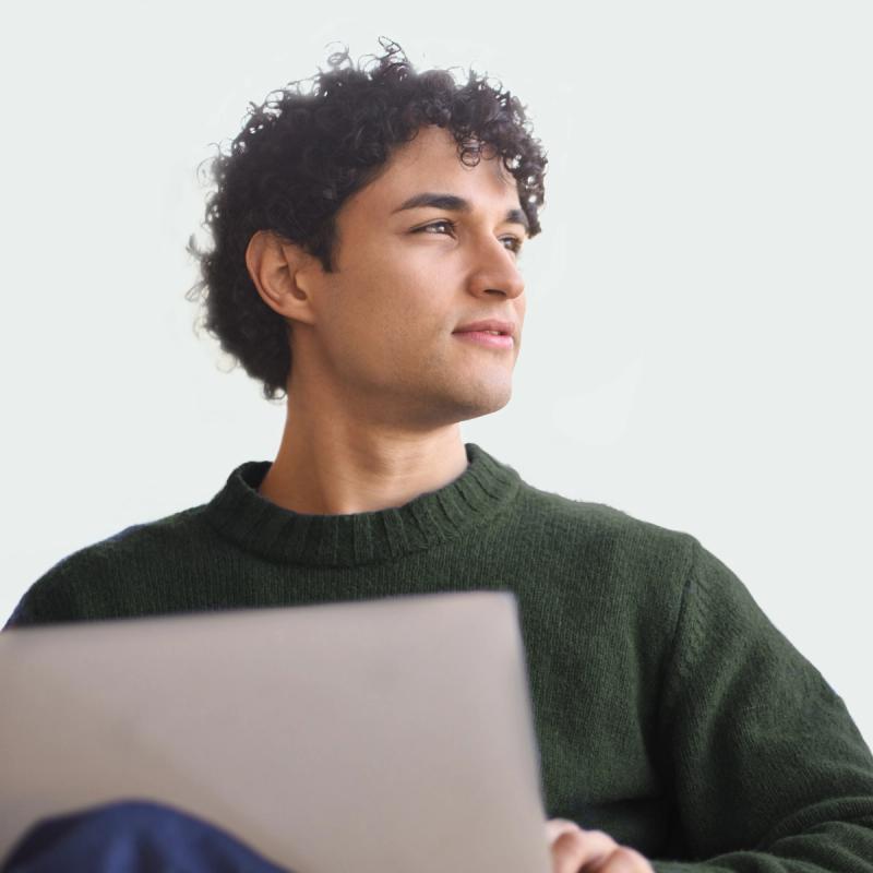 Man Looking Away From a Computer