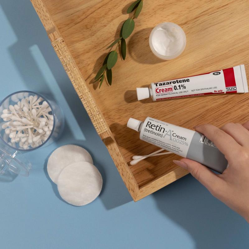 An illustration of a person, with a concerned body posture, with facial wrinkles, applying an anti-aging cream and looking into a mirror.