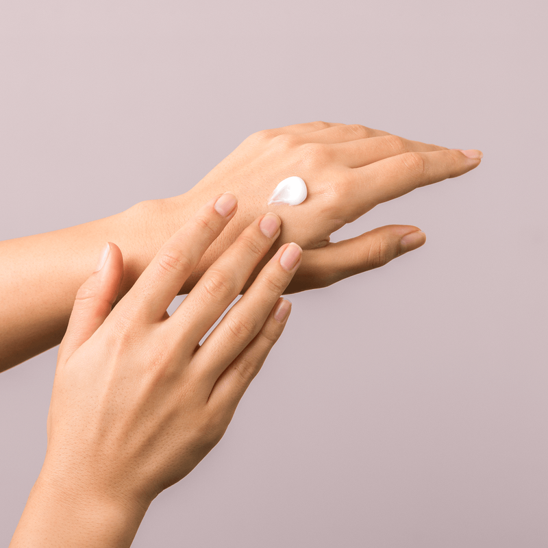 Hand applying skincare cream