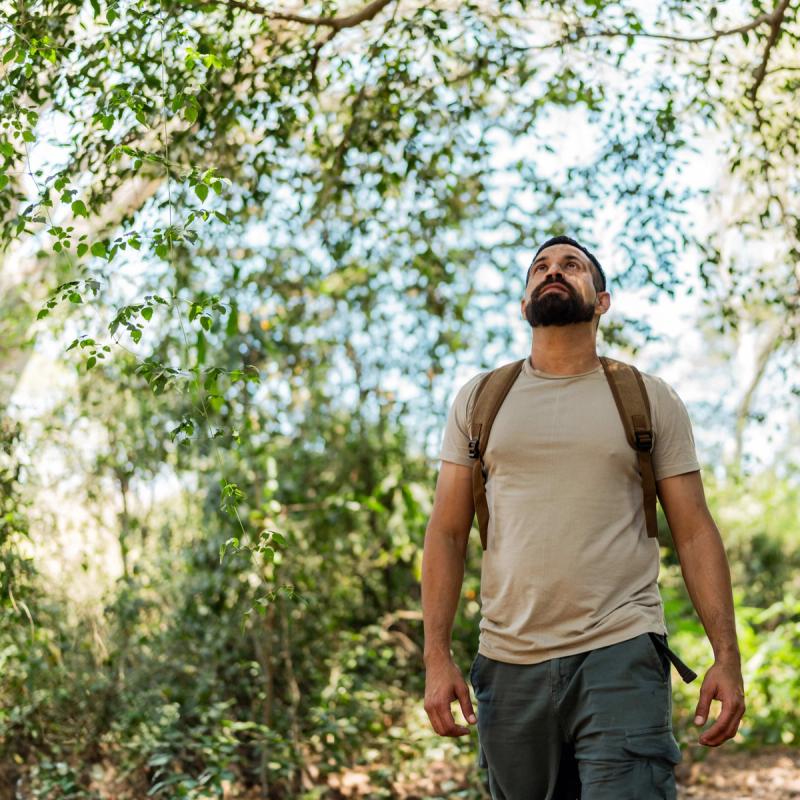 Man with a backpack hiking in a forest