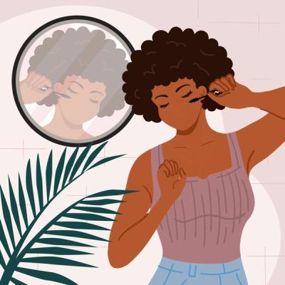 Women looking in mirror applying mascara. 