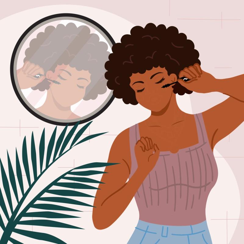 Women looking in mirror applying mascara. 