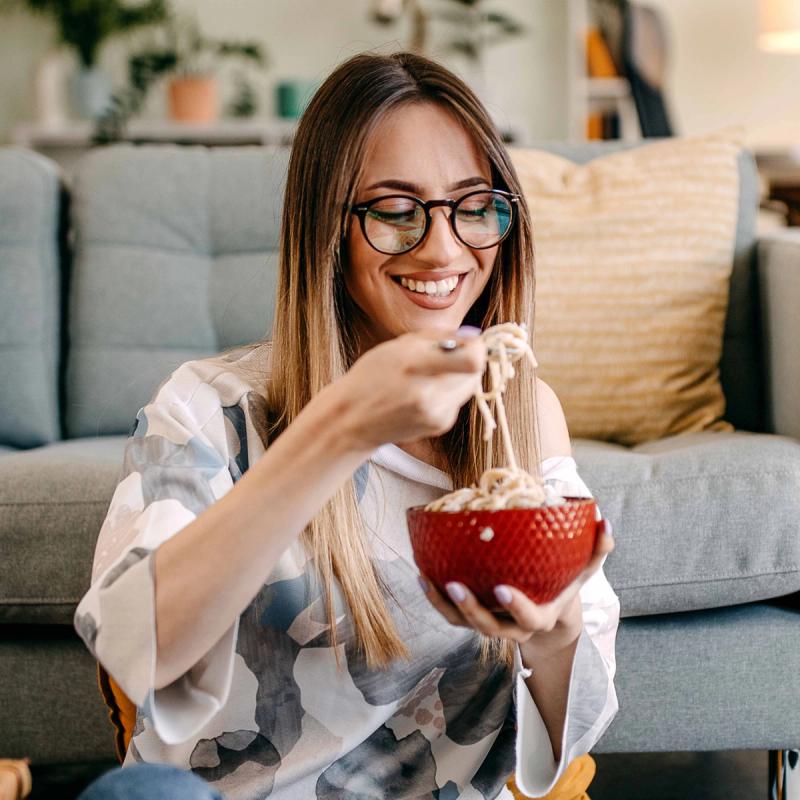 Woman enjoying a meal without nausea.
