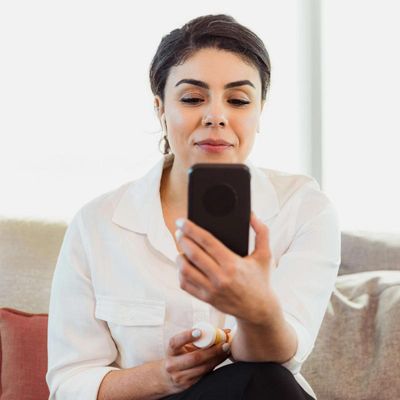 Woman on phone conducting online consult