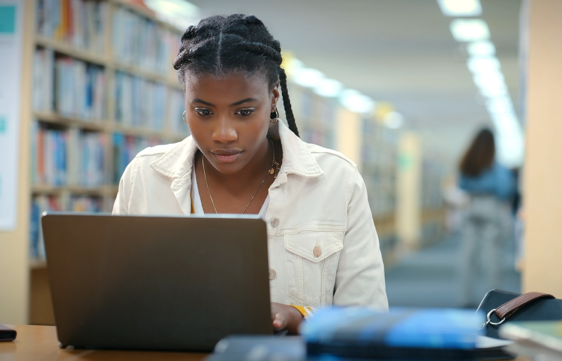 Woman working on her computer in an office setting.