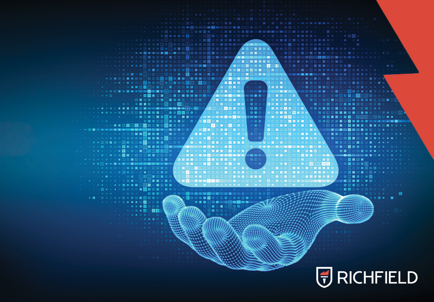 Digital hand holding a warning sign with the Richfield logo in the bottom right corner.