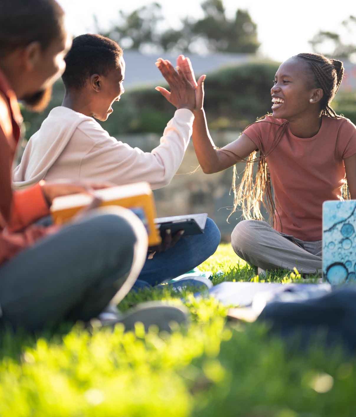 Students socialising outside on the grass