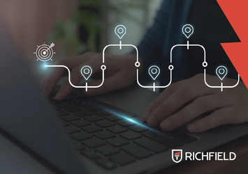 Working on a laptop with a dark grey overlay and an illustrated map drawn over the image.