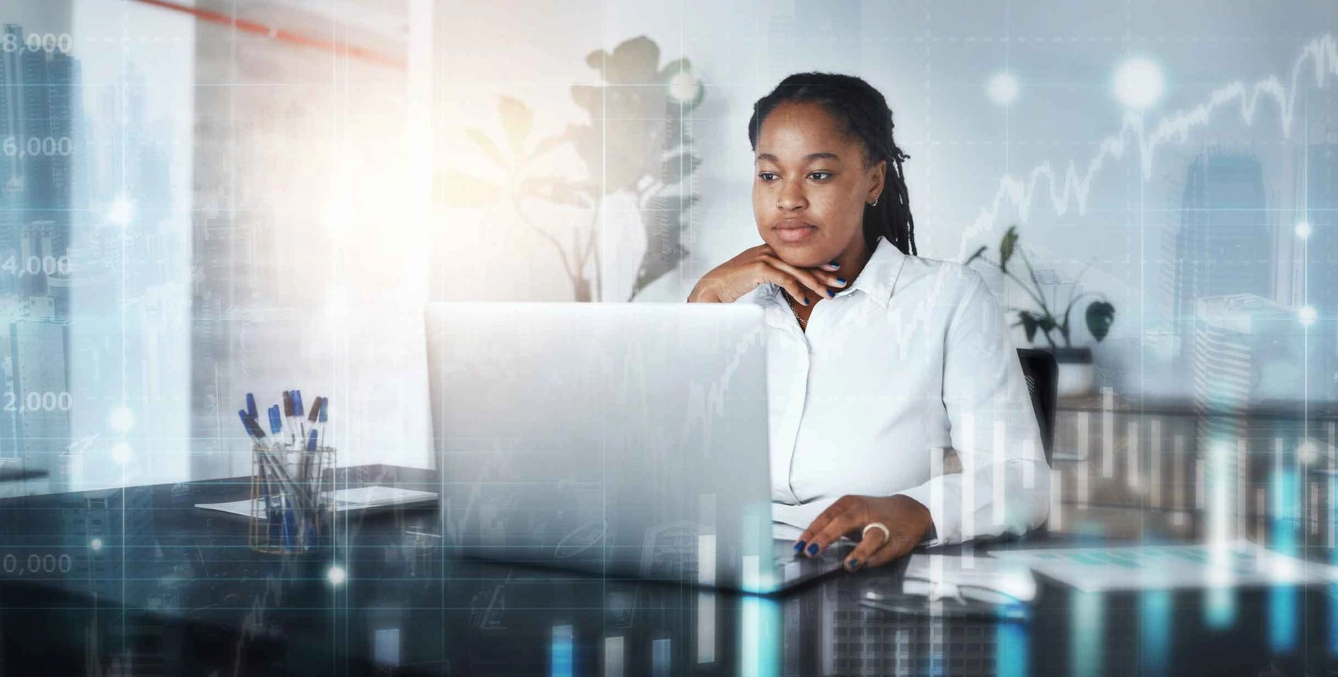 Woman working on her computer in an office setting.