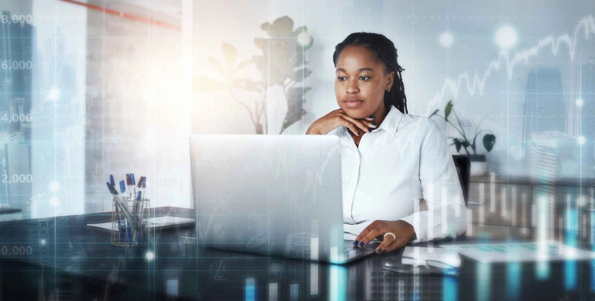Woman working on her computer in an office setting.