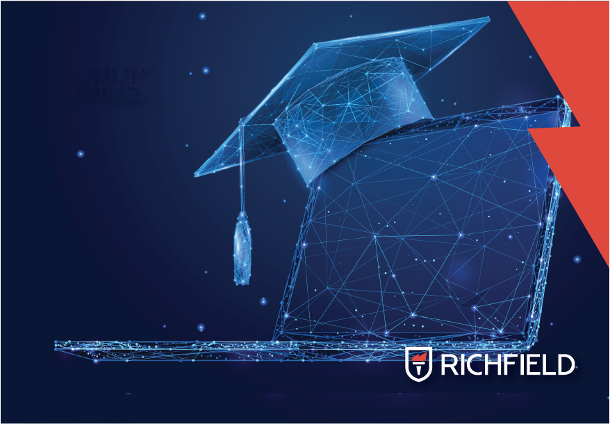 Graduation cap sitting on a laptop with Richfield logo in corner.