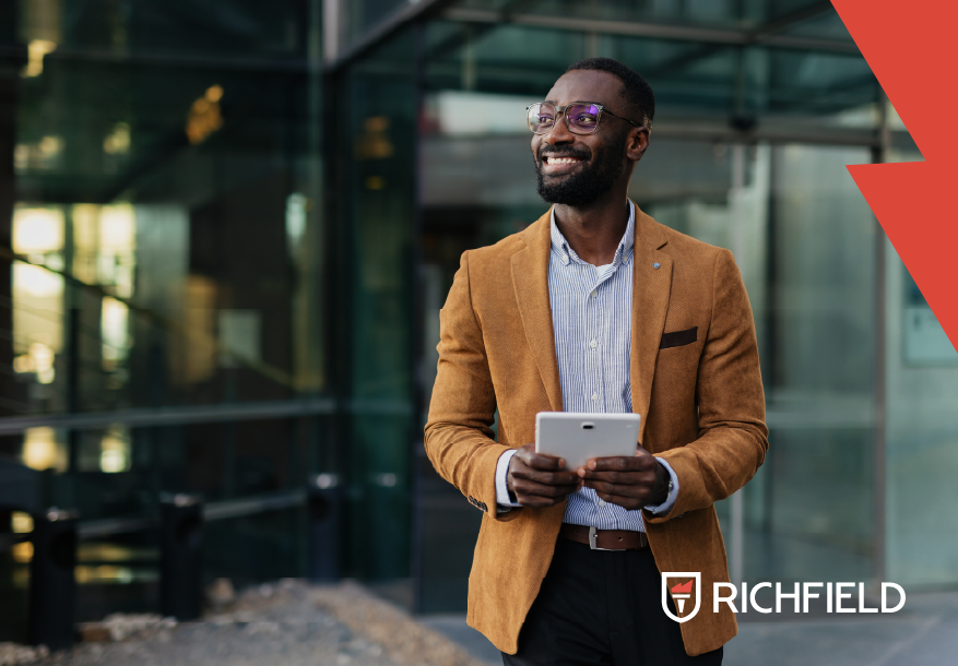 Young professional standing outside an office building