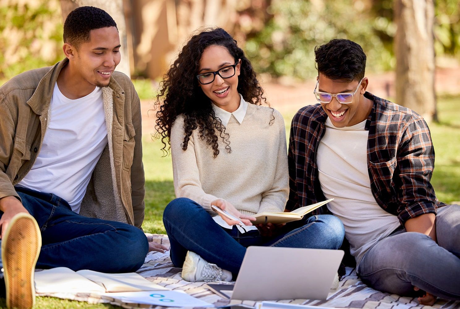 students with laptop outside