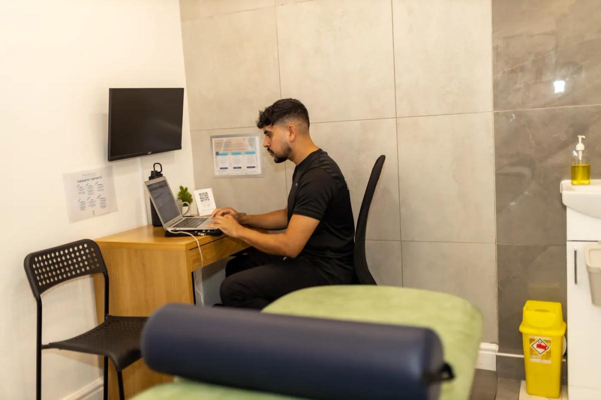 Office worker at a desk experiencing neck discomfort