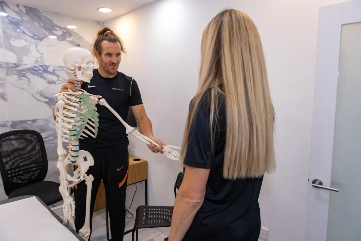 Physiotherapist assessing a patient's shoulder mobility