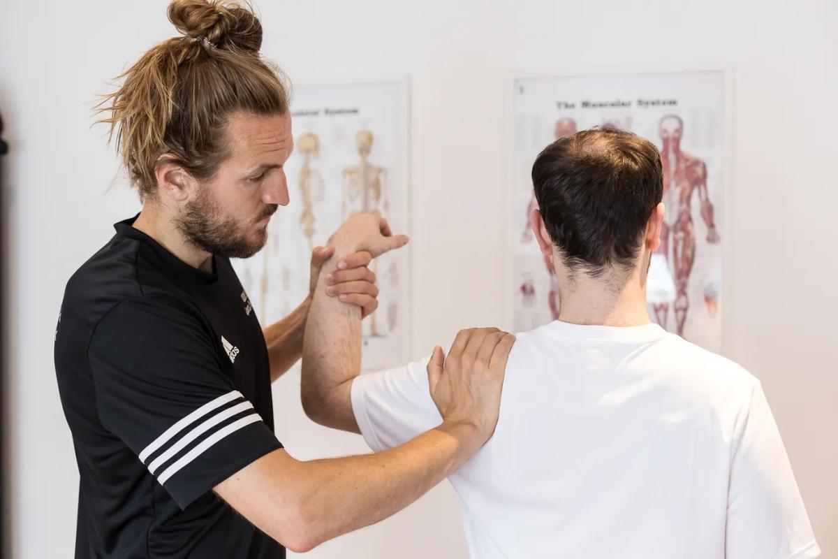 Physiotherapy team treating a shoulder
